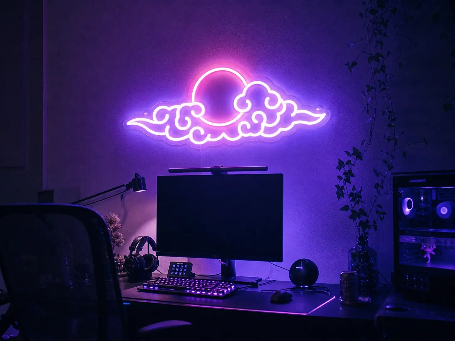 Glowing purple and pink neon wall sign above a gaming desk