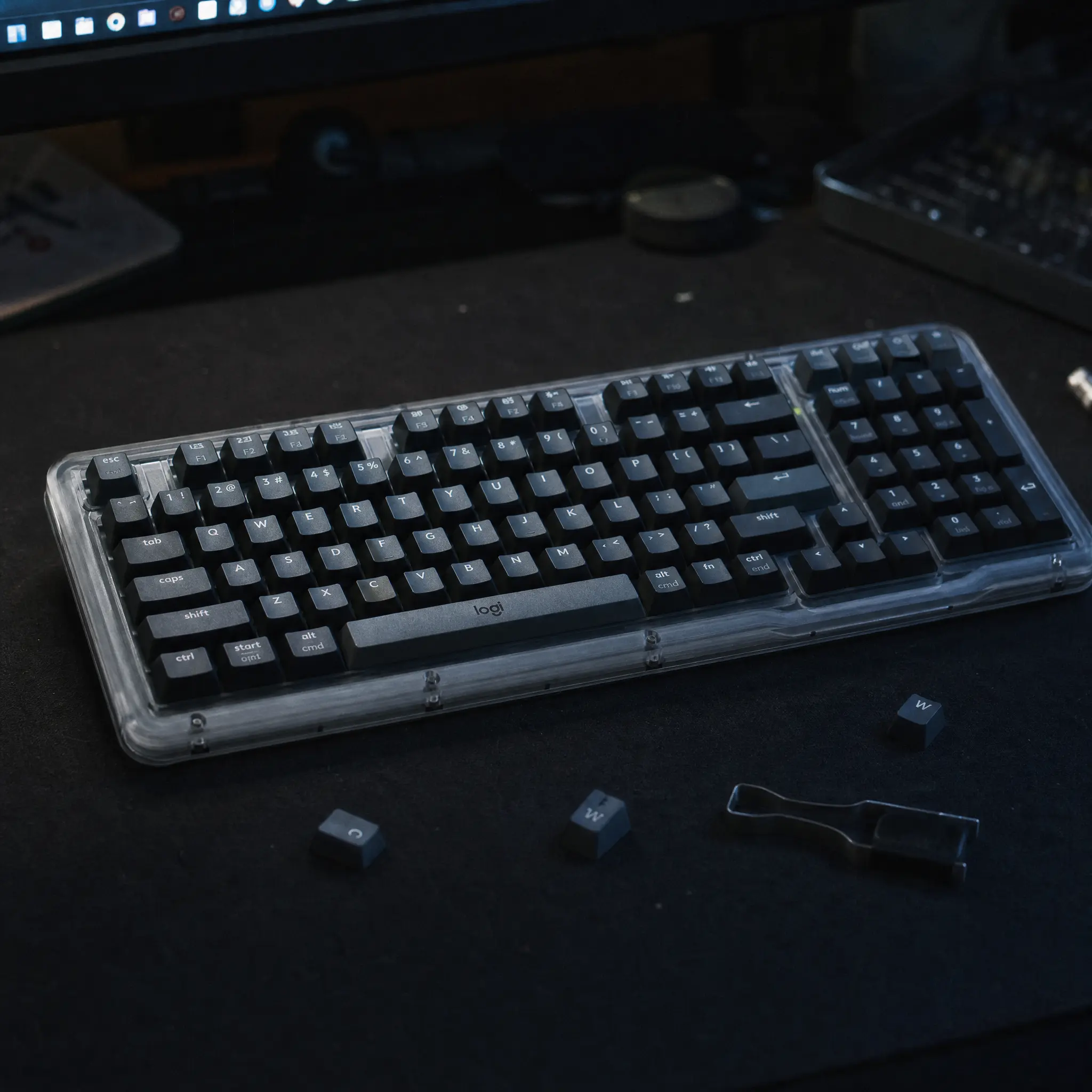 Premium dark grey wireless mechanical keyboard on black desk mat