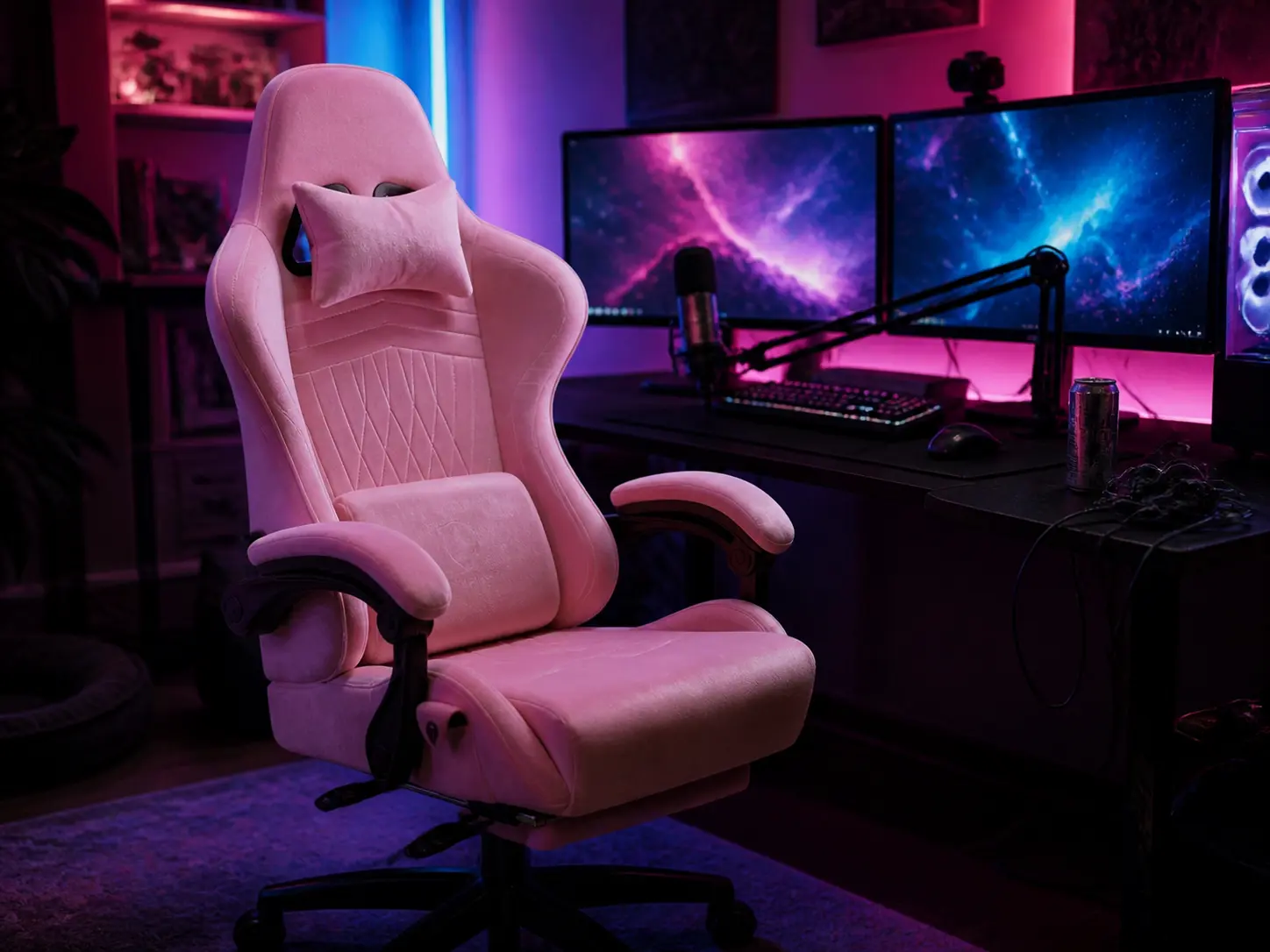Sleek premium quartz pink ergonomic gaming chair at a dark desk with dual monitors