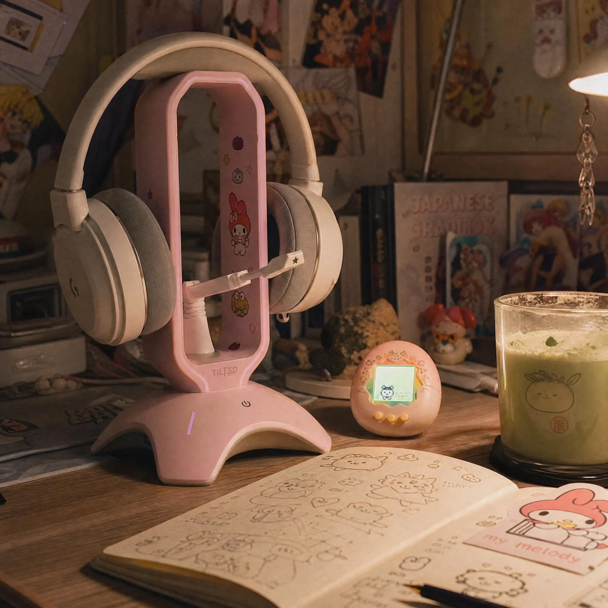 Pink kawaii headphone stand holding a cute gaming headset on a wooden desk