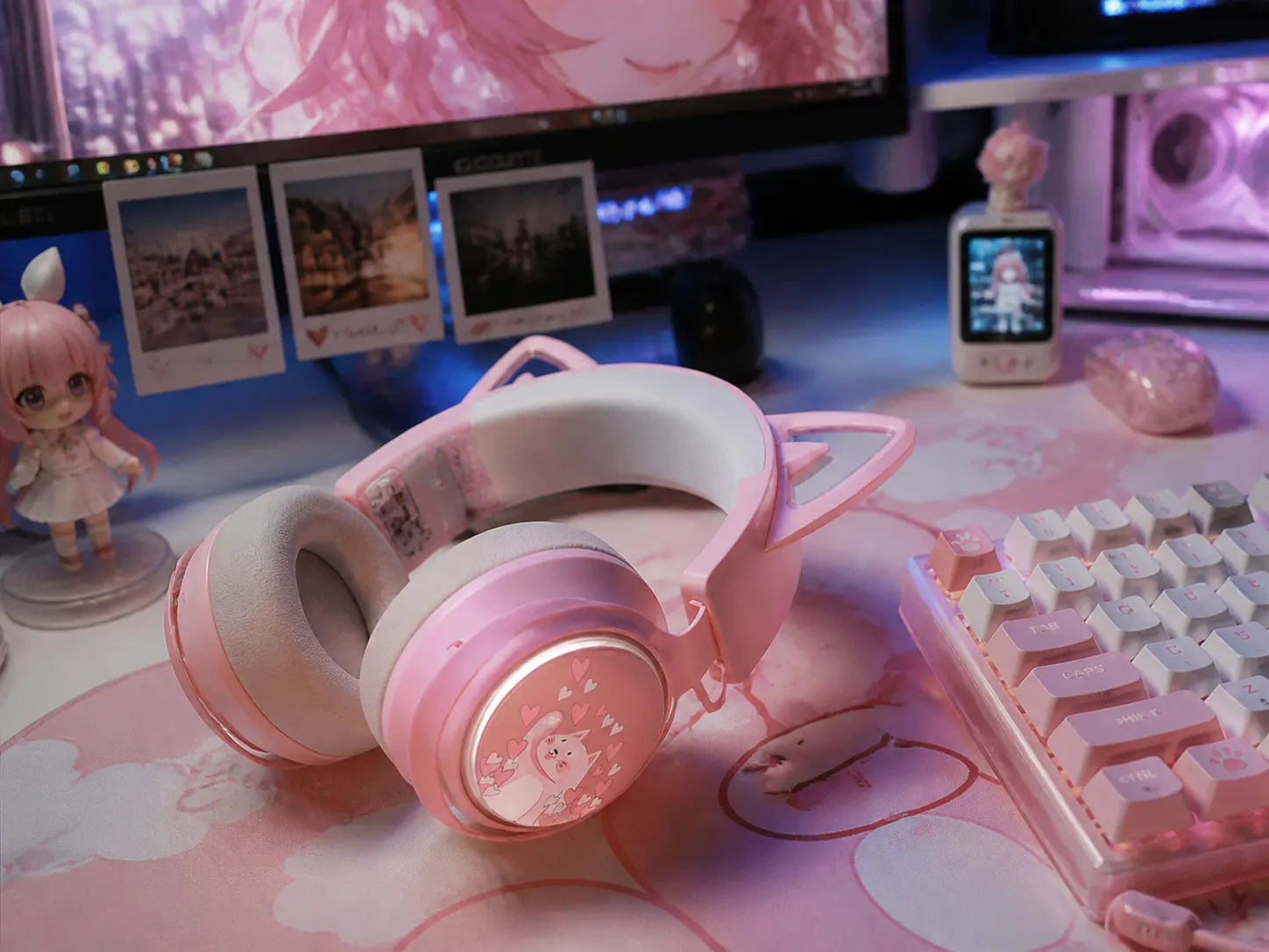 Wireless pastel white and pink cat ear headset resting naturally on a soft desk mat