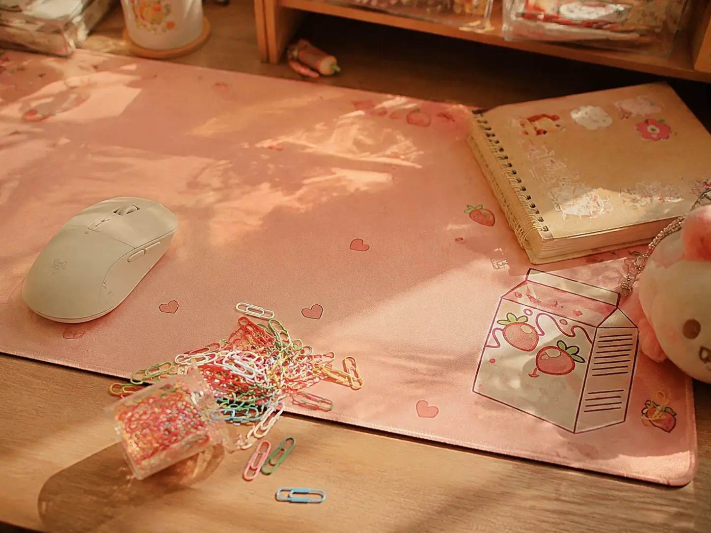 Cute pastel peach colored large desk mat on a cozy desk setup