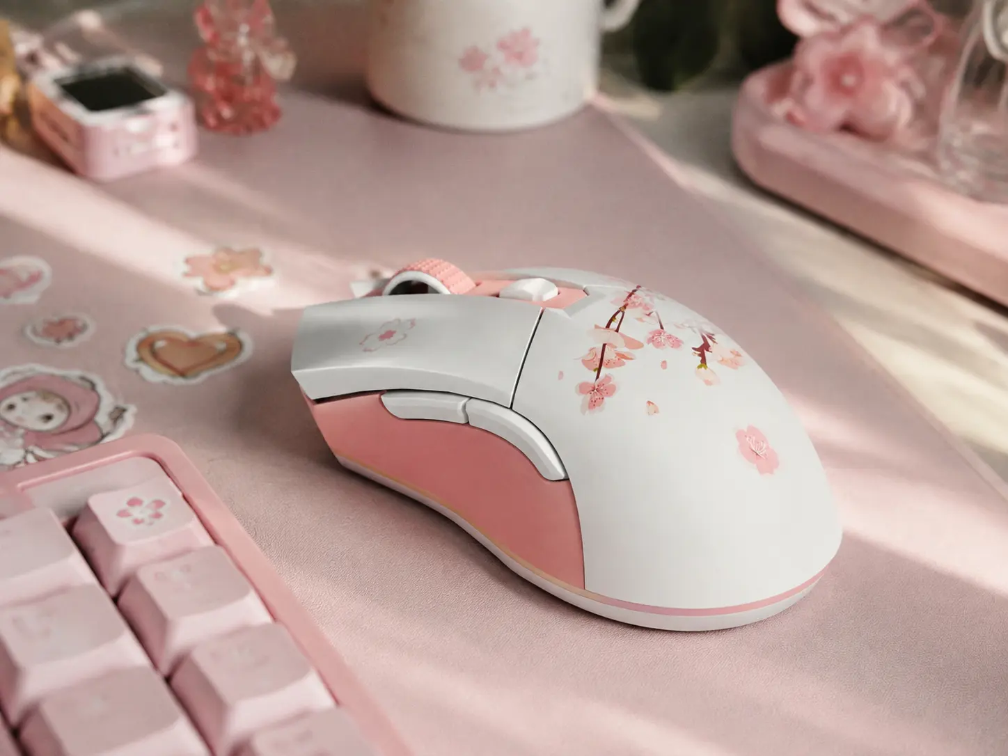 Pastel pink wireless mouse on a pink aesthetic desk mat