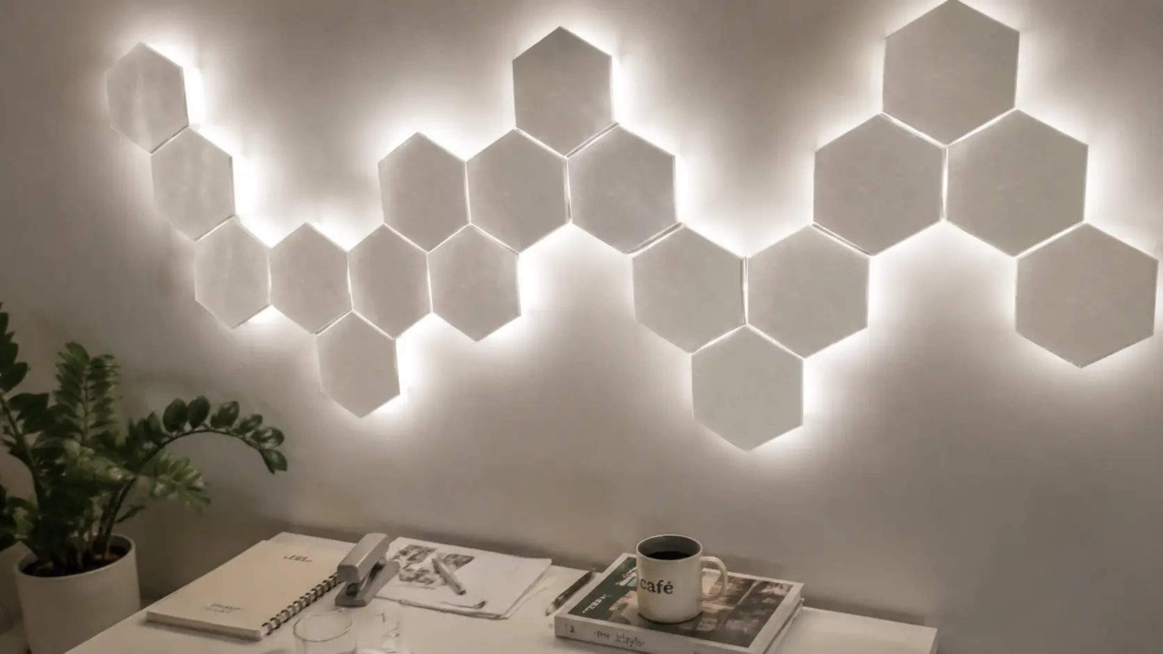 Cozy white hexagon RGB wall panels glowing above a minimalist desk setup