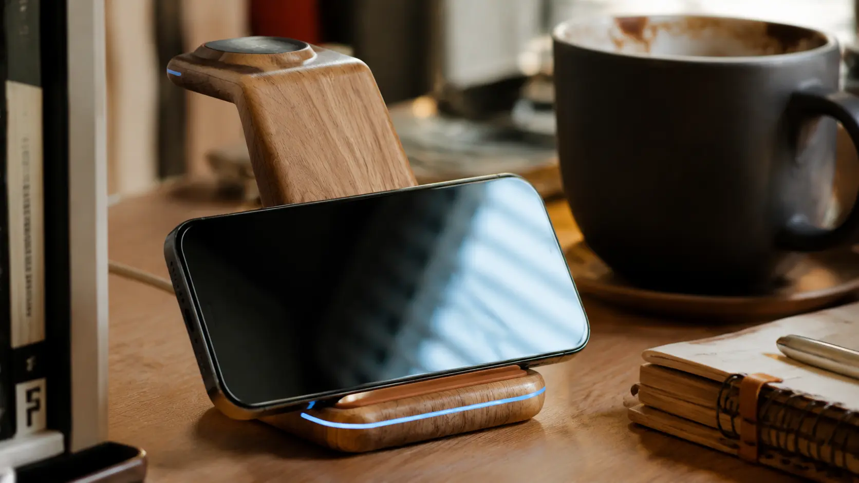 Close up of a sleek wooden wireless charger on a cozy aesthetic desk