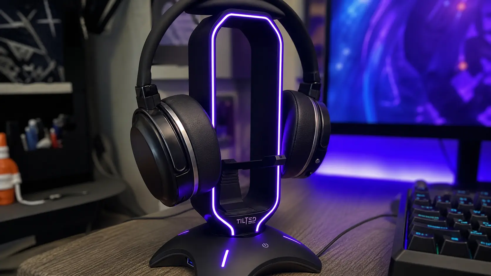 Close up of a glowing RGB headphone stand on a gamer desk