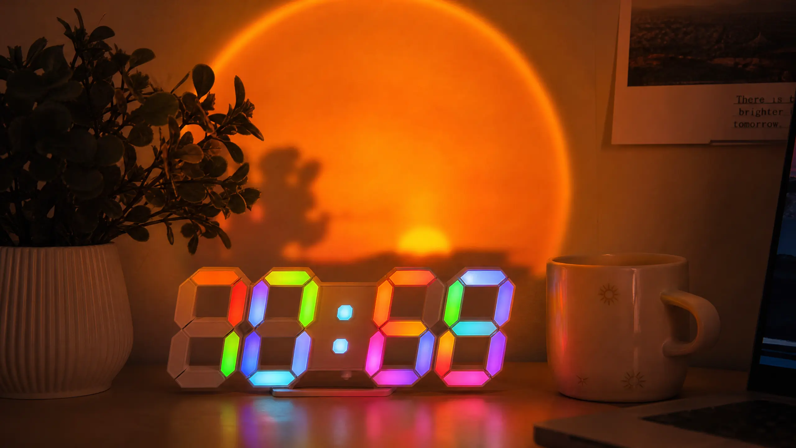 Close up of a retro flip clock on a cozy desk illuminated by warm amber light