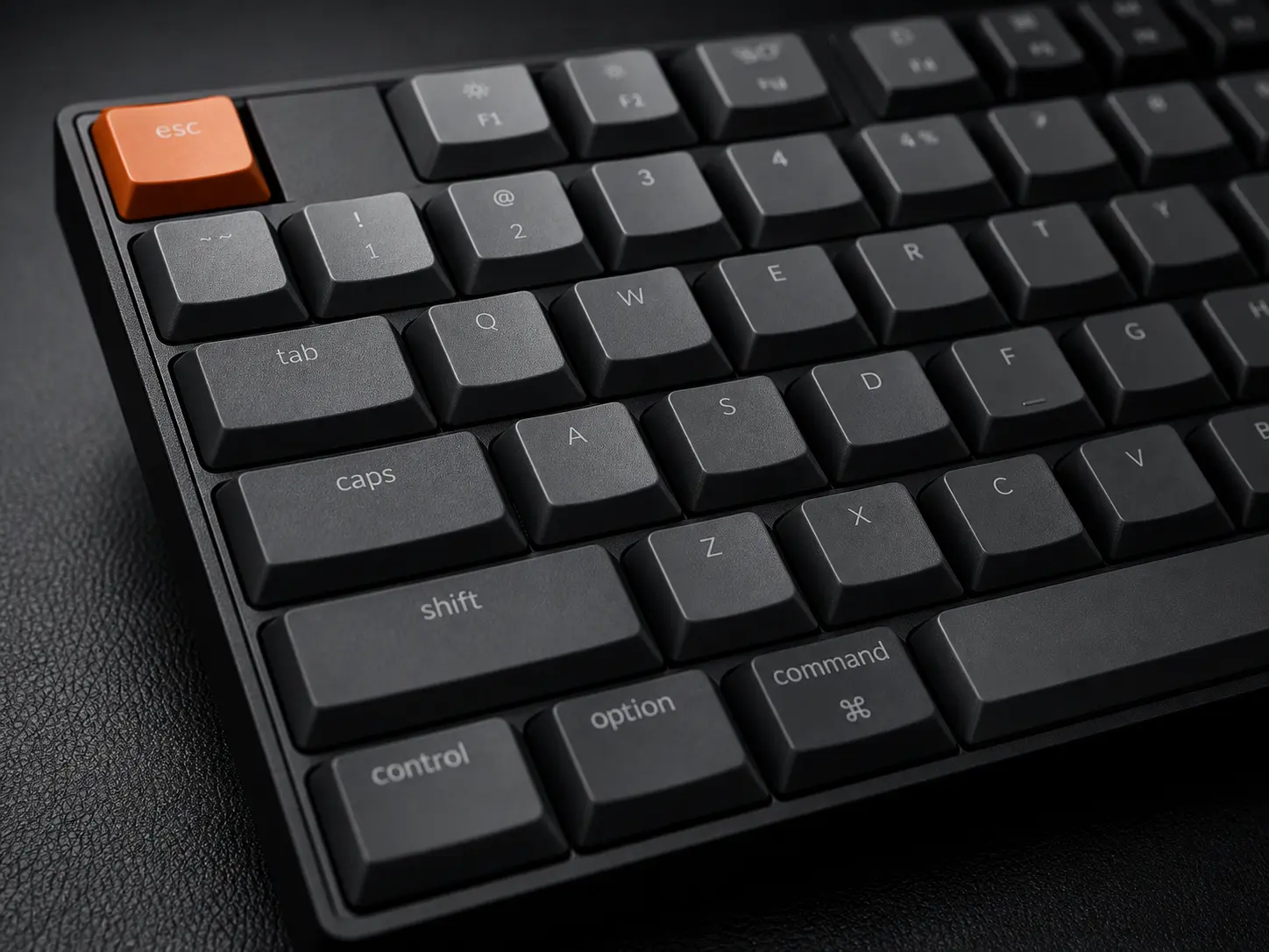 Low Profile Wireless Mechanical Keyboard Matte Black on a leather desk pad