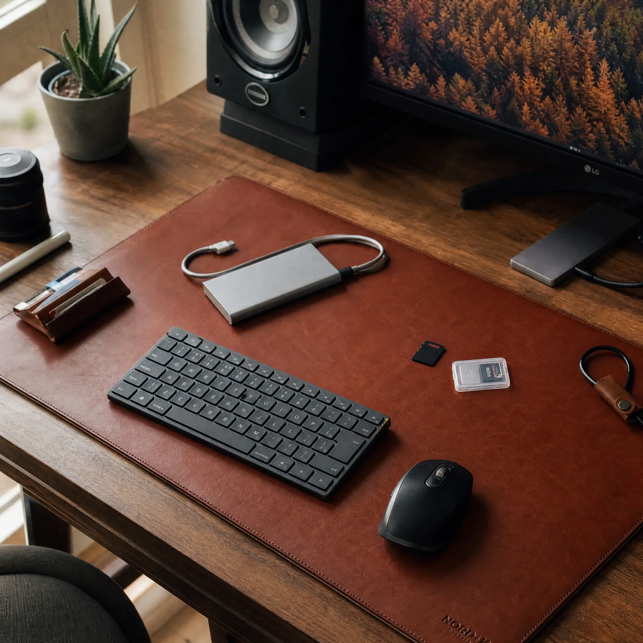Premium leather desk pad with tech accessories and aesthetic clutter