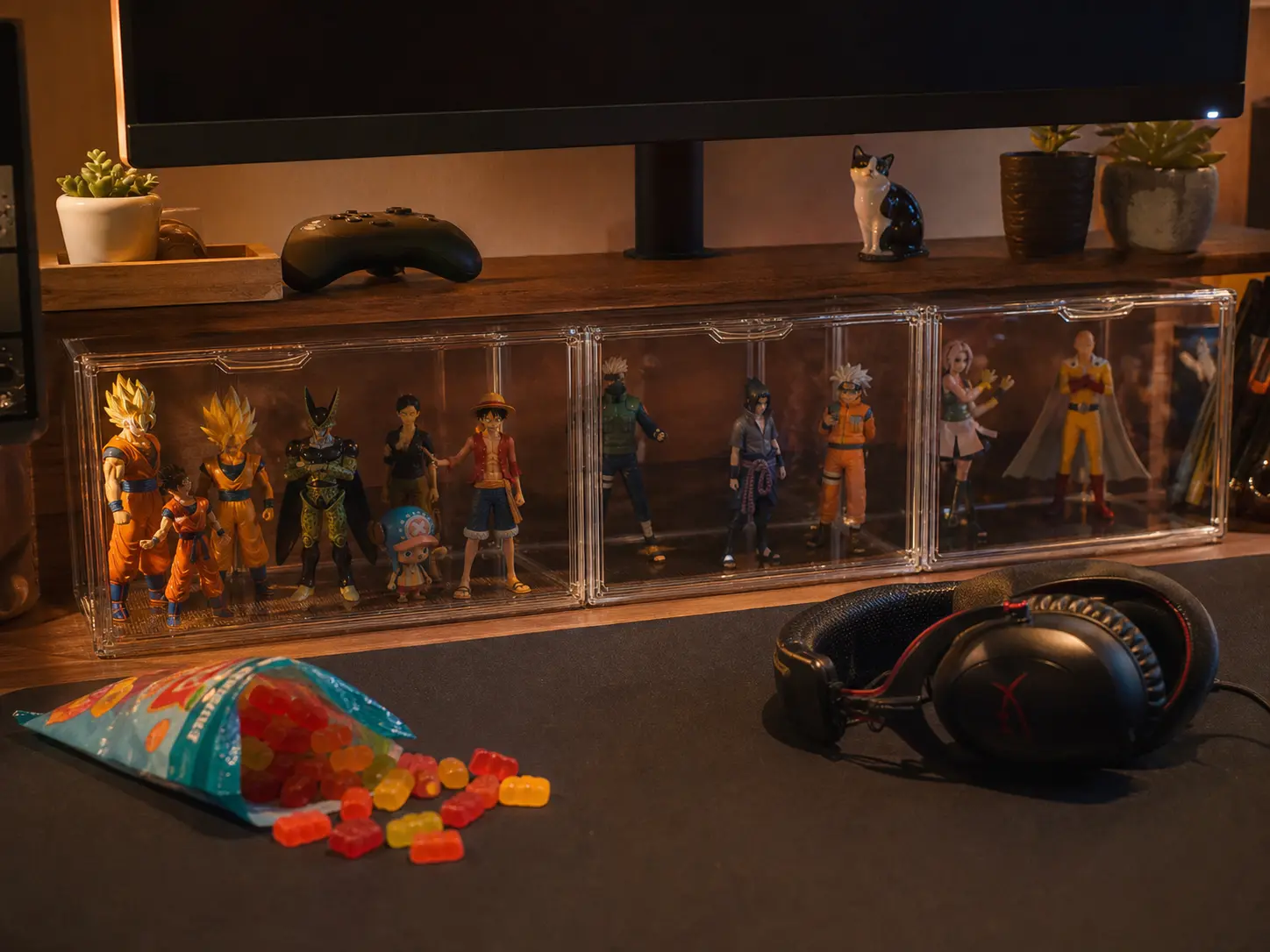 Long magnetic acrylic figure display case sitting under a computer monitor with gaming accessories