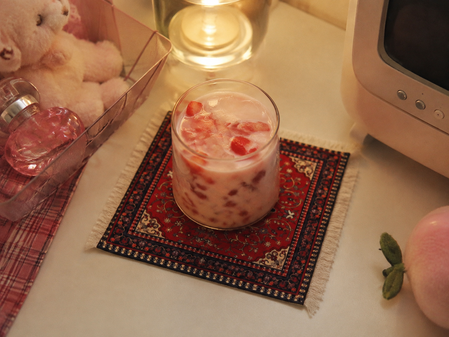 Cute fluffy mini tufted rug coaster with a glass of strawberry milk