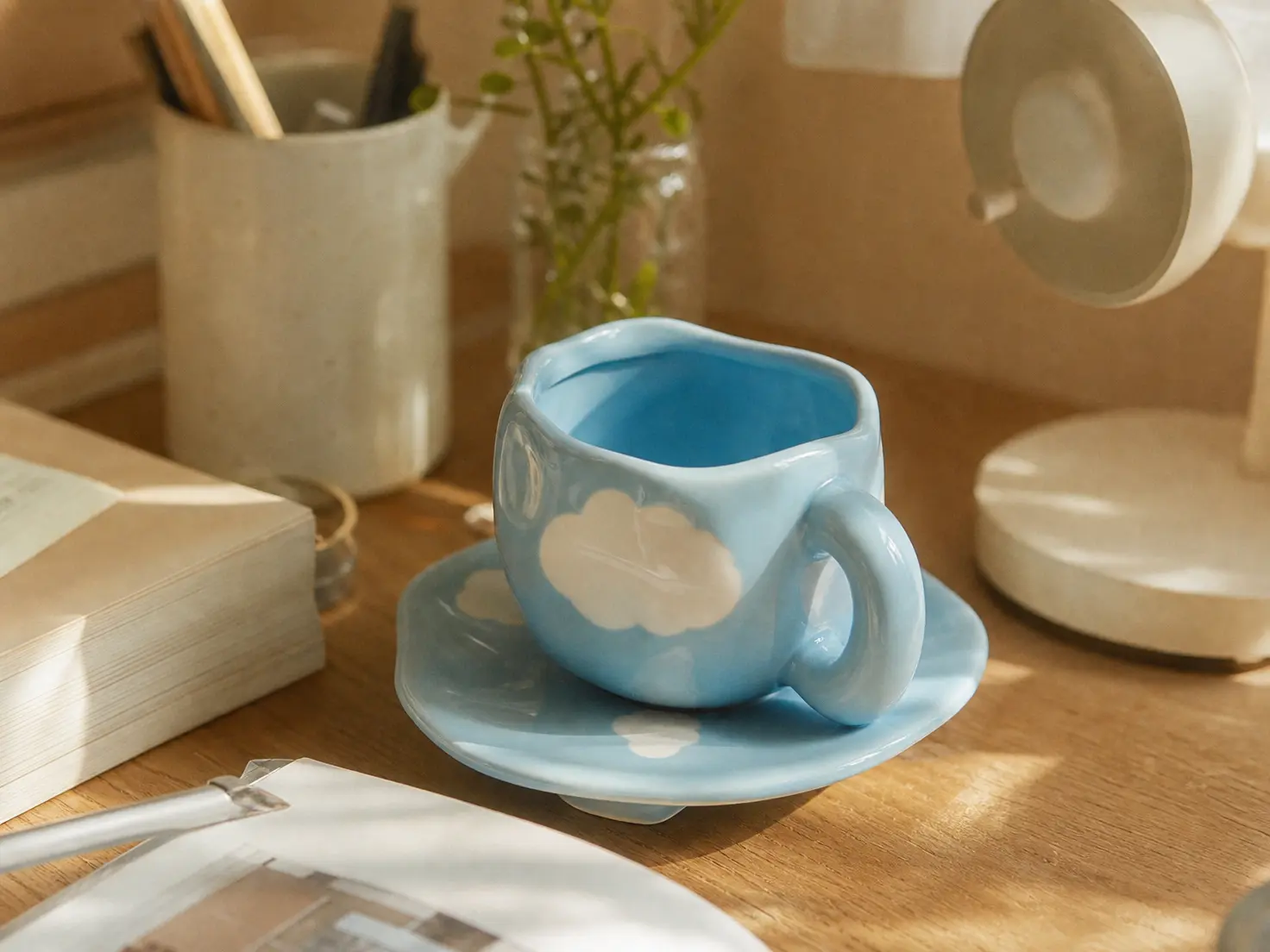 Trendy pastel chunky ceramic mug with a thick handle on a cozy aesthetic desk