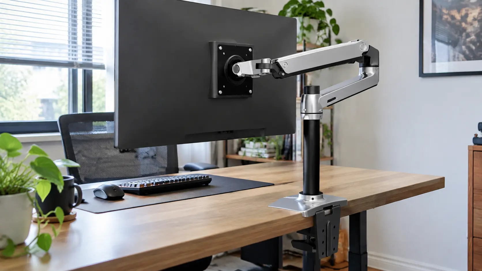 Ergotron LX heavy-duty monitor arm clamped to a desk