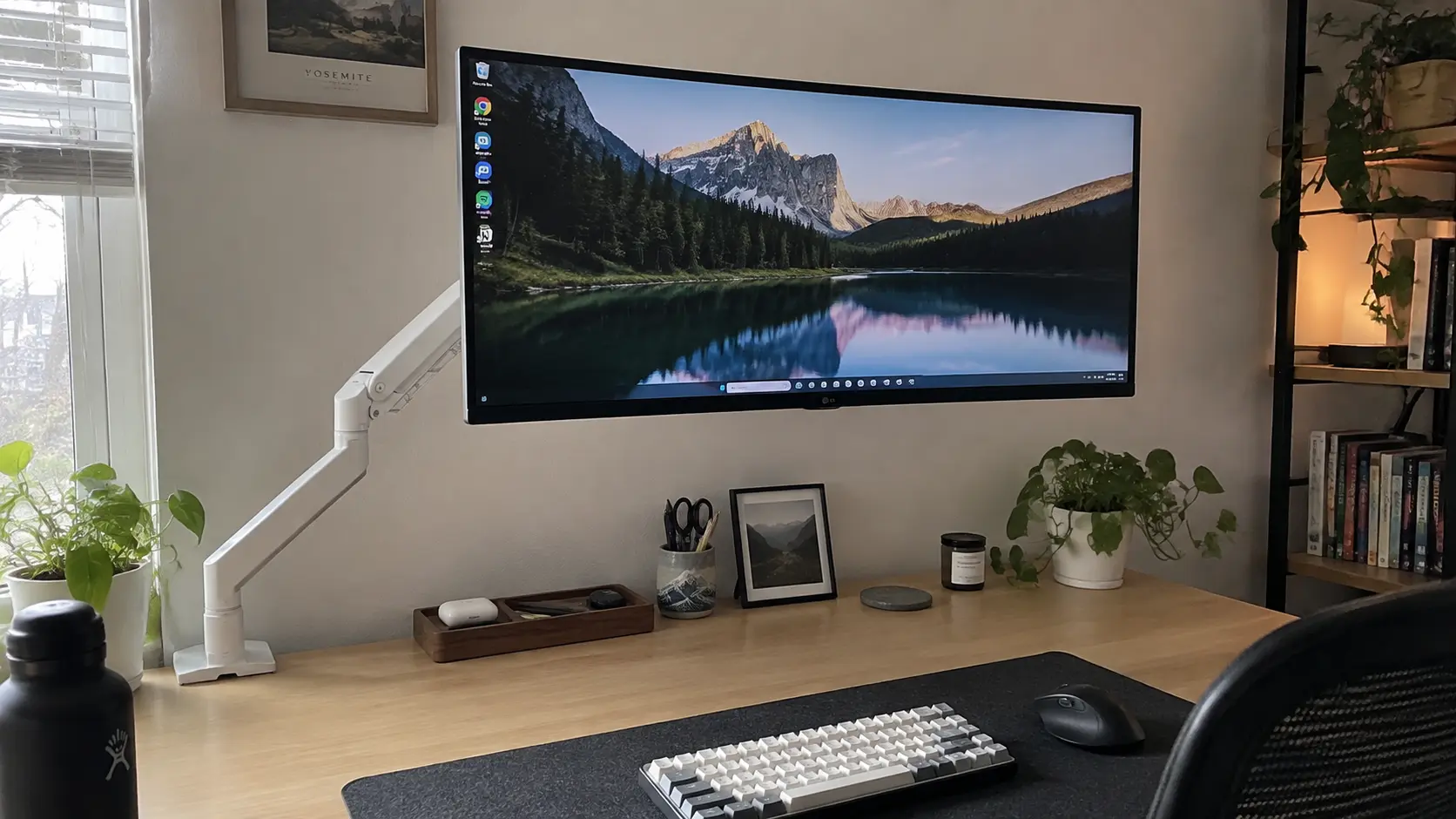 VIVO Premium white monitor arm holding a screen above a clean desk